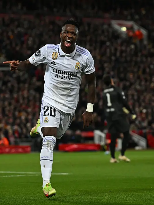 <p>Pemain Real Madrid, Vinicius Jr melakukan selebrasi setelah mencetak gol penyeimbang 2-2 melalui blunder kiper Liverpool, Alisson Becker saat laga leg pertama Liga Champions 2022/2023 melawan Real Madrid yang berlangsung di Anfield, Rabu (22/02/2023) WIB. Liverpool kalah dengan skor 2-5 dari Real Madrid. (AFP/Paul Ellis)</p>