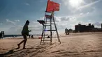 Sebuah kursi penjaga pantai yang kosong berdiri di Coney Island, salah satu tujuan pantai paling populer di wilayah Brooklyn di New York City (29/6/2022). Kota New York menghadapi kekurangan penjaga pantai di kolam renang kota dan pantai tahun ini, memaksa beberapa daerah untuk membatasi waktu berenang. (Spencer Platt/Getty Images/AFP)