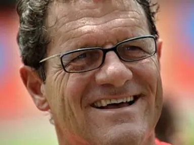 England coach Fabio Capello gestures as he coaches children during a football clinic at Rajamangala Stadium in Bangkok on July 26, 2008. Capello will hold clinics/ NICOLAS ASFOURI 