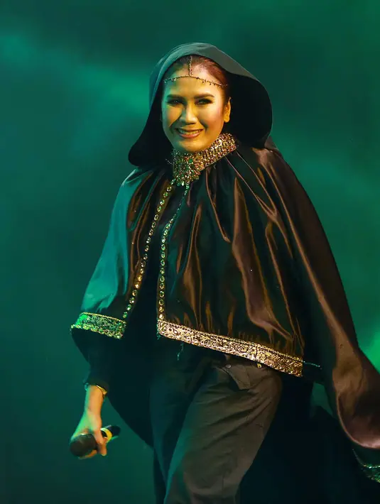 Senyum manis 'lady rocker' dari Indonesia ini diberikan kepada para penonton yang memenuhi area panggung Kampung GaSS 2 yang telah ramai dari siang hari tersebut. (Deki Prayoga/Bintang.com)