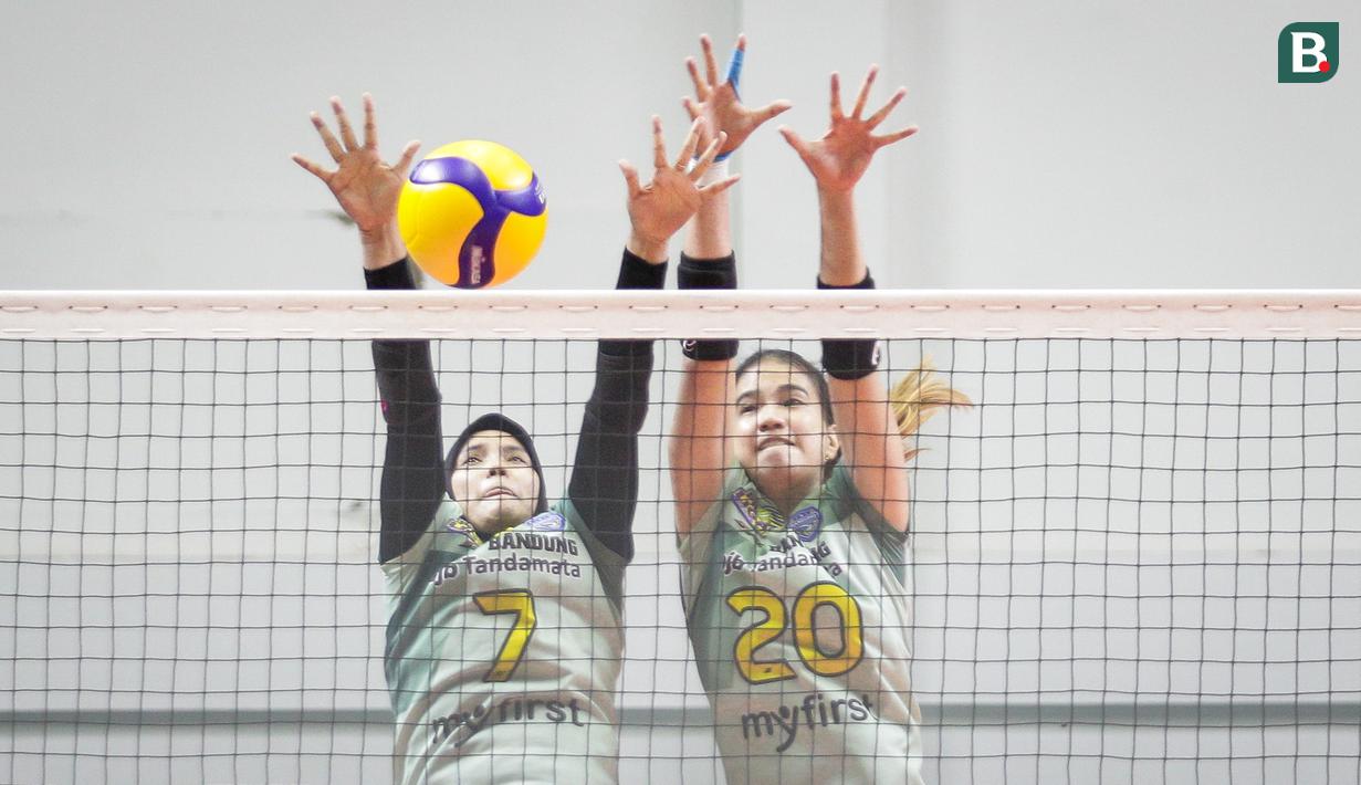 Pemain Bandung BJB Tandamata, Shella Bernadetha Onan (kanan) dan Nandita Ayu Salsabilla melakukan berusaha menghalau bola saat laga lanjutan Proliga 2022 melawan Jakarta Elektrik PLN di Padepokan Voli Jenderal Polisi Kunarto, Sentul, Jumat (21/01/2022). (Bola.com/Bagaskara Lazuardi)