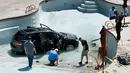 Pekerja membersihkan puing-puing mobil yang masuk ke kolam renang setelah seorang wanita berusia 73 tahun keliru menginjak gas saat ia ingin menekan rem di Cheyenne Mountain Resort, Colorado Springs, (4/7). (Jerilee Bennett /The Gazette via AP)