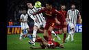Pemain Juventus, Dusan Vlahovic (kiri) berebut bola dengan pemain AS Roma, Chris Smalling pada laga pekan ke-25 Liga Italia 2022/2023 yang berlangsung di Stadio Olimpico, Senin (06/03/2023) dini hari WIB. (AFP/Filippo Monteforte)