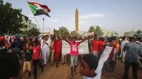 Warga Sudan menyanyikan slogan dan mengibarkan bendera nasional saat mereka merayakan kemenangan di Khartoum (Ashraf Shazly / AFP)