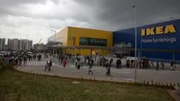Para pelanggan berjalan di luar IKEA saat membuka toko pertamanya di Hyderabad, Kamis (9/8).  Perusahaan furnitur Swedia itu membuka toko pertamanya di India, lima tahun setelah menerima persetujuan untuk berinvestasi di negara itu. (AP/Mahesh Kumar A.)