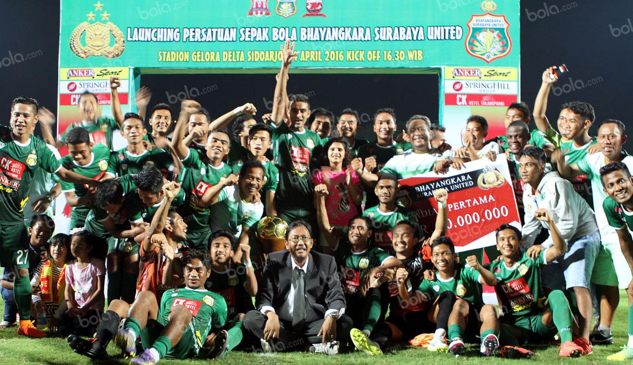 Ekspresi pemain Bhayangkara Surabaya United dengan trofi juara Trofeo Kapolda Jatim di Stadion Gelora Delta, Sidoarjo, Minggu (24/4/2016). (Bola.com/Zulfirdaus Harahap)
