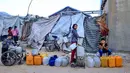 Rusak atau hancurnya sekitar 90 persen infrastruktur air dan sanitasi di Gaza juga menjadi penanda situasi krisis kemanusiaan yang ekstrem. Tampak dalam foto, anak-anak menunggu untuk mengisi wadah dengan air di kamp pengungsi Palestina, Nuseirat, Jalur Gaza Tengah pada Kamis 7 Mei 2026. (Eyad Baba/AFP)