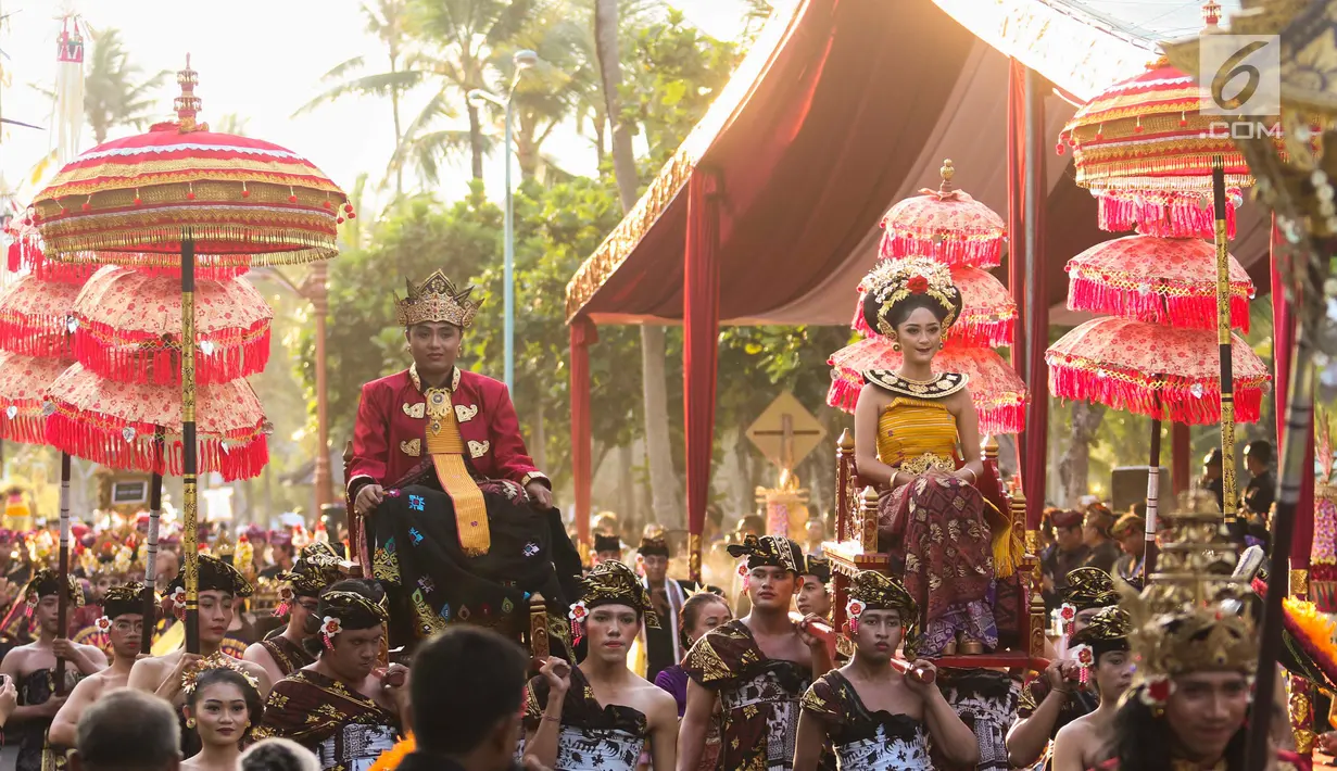 Peserta mengenakan pakaian adat pernikahan pada karnaval Budaya Bali di kawasan Nusa Dua, Bali, Jumat (12/10). Karnaval tersebut untuk memeriahkan perhelatan Pertemuan Tahunan IMF - World Bank Group 2018 di Bali. (Liputan6.com/Angga Yuniar)