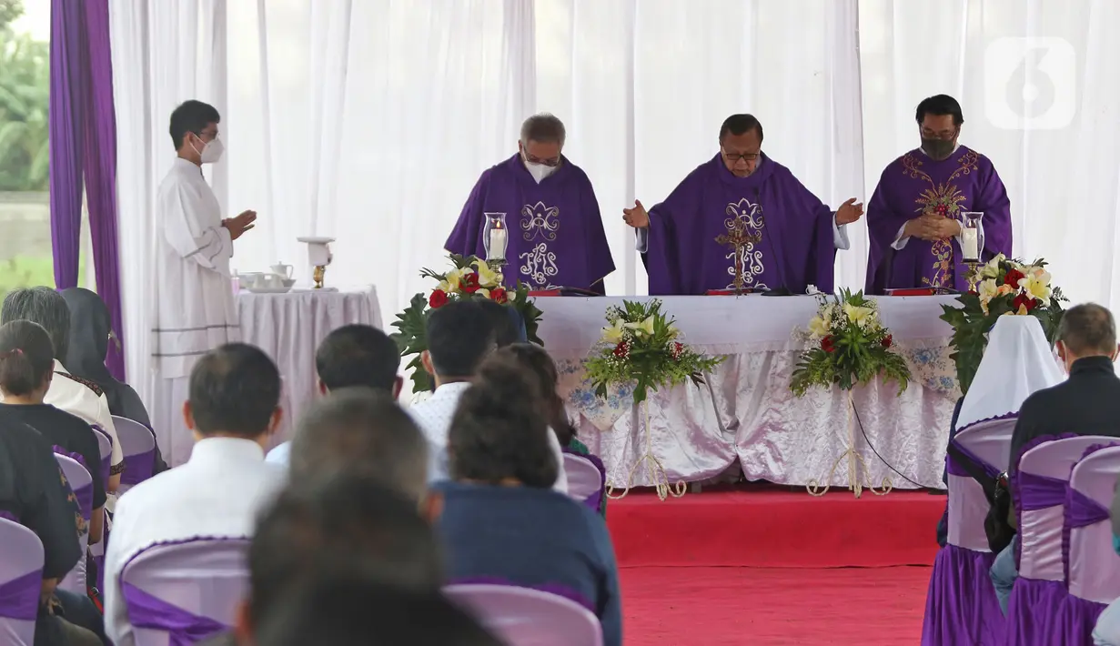 Uskup Ignatius Kardinal Suharyo (tengah) memimpin misa perayaan ekaristi peringatan arwah bagi korban Covid-19 di area TPU Rorotan, Jakarta Utara, Selasa (30/11/2021). Misa tersebut untuk mendoakan arwah korban Covid-19. (Liputan6.com/Herman Zakharia)