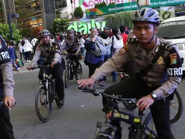 Petugas kepolisian berpatroli sepeda di Senayan, Jakarta, Minggu (2/9). Untuk meminimalisasi kemacetan jelang penutupan Asian Games 2018, rekayasa lalu lintas dilakukan di sejumlah ruas jalan dari dan menuji Senayan. (Liputan6.com/Immanuel Antonius)