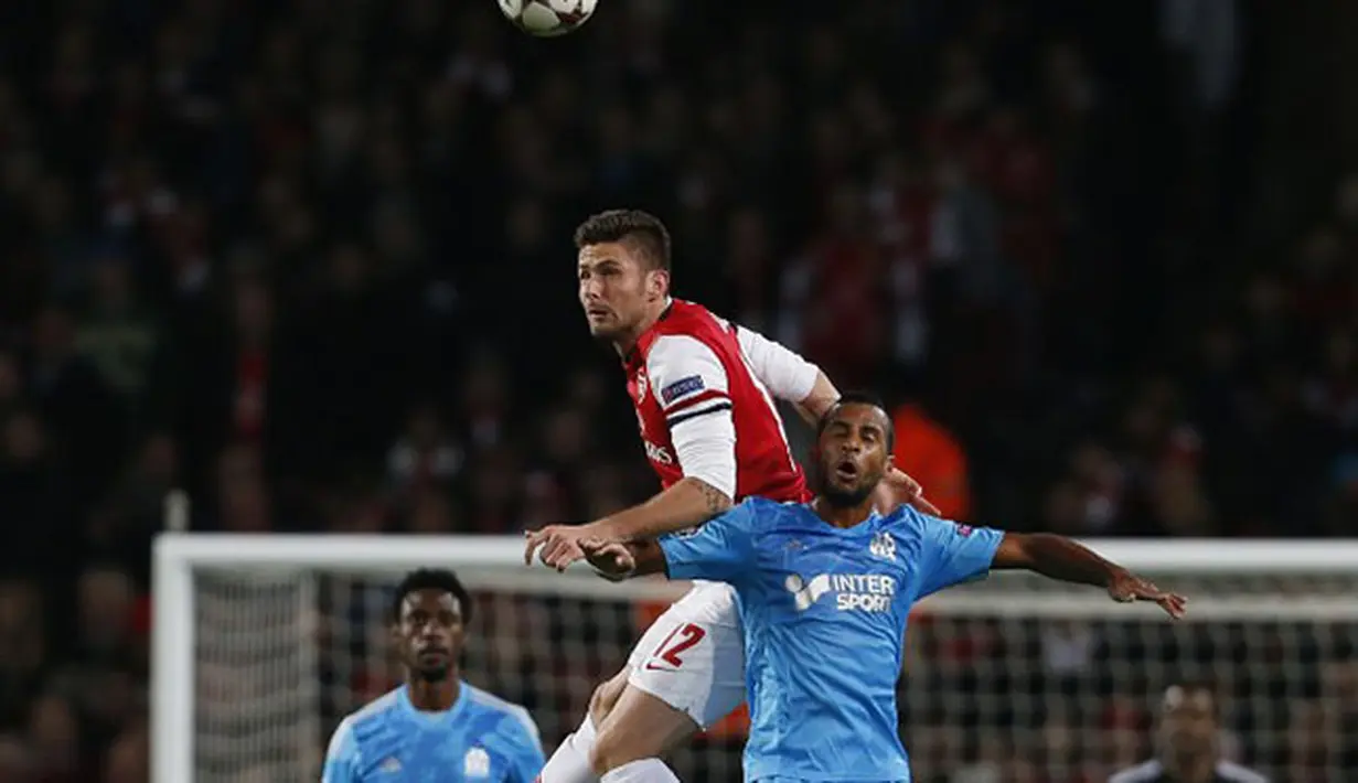 Duel udara antara Olivier Giroud dan Jacques-Alaixys Romao pada Liga Champions Grup F antara Arsenal dan Olympique de Marseille di Stadion Emirates (27/11/2013).(AFP/Adrian Dennis).
