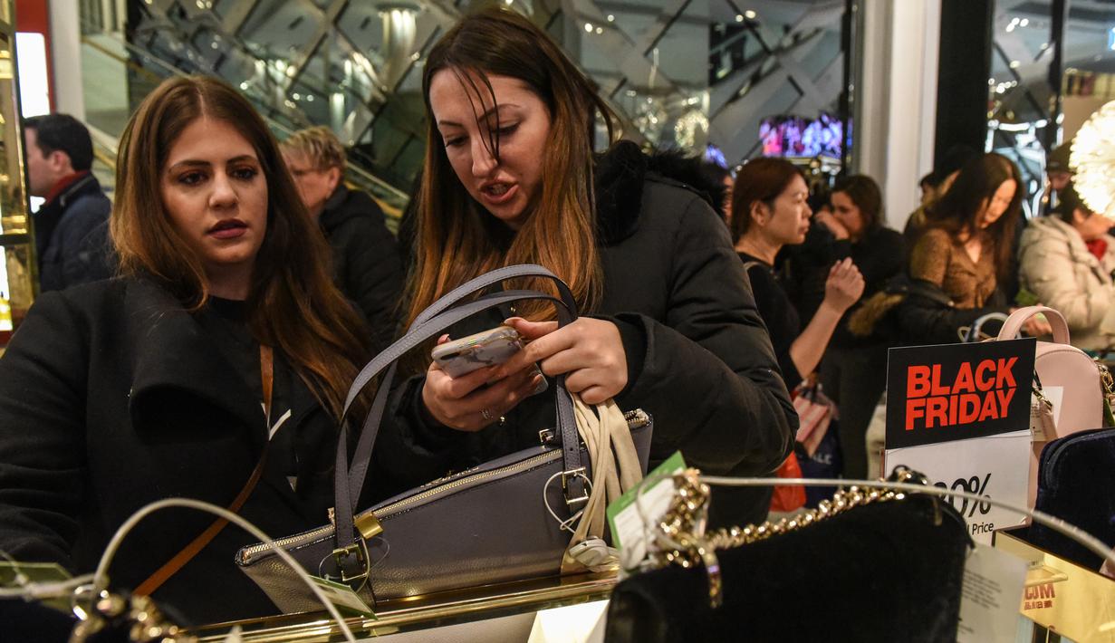 Pembeli memilih tas yang dibanderol diskon selama perayaan Black Friday di Macy Herald Square, New York, Kamis (24/11). Black Friday adalah tradisi hari belanja terbesar tahunan di Amerika sehari setelah Thanksgiving. (STEPHANIE KEITH/GETTY IMAGES/AFP)