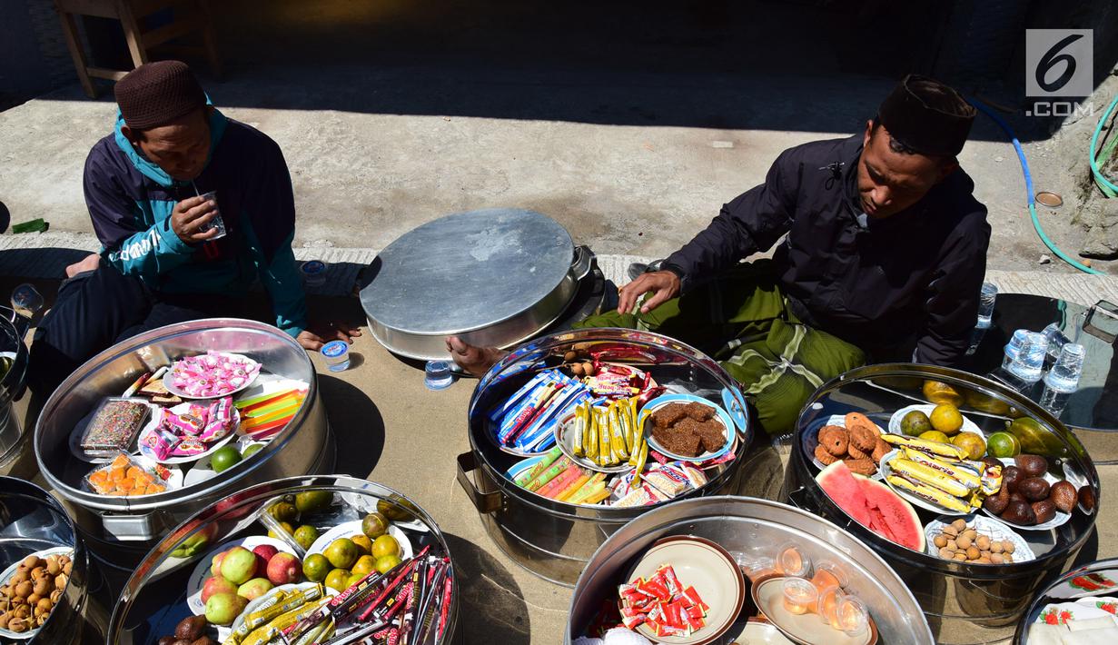 Warga membawa makanan di Kabupaten Boyolali, Kamis (3/5). Tradisi ini Sebagai perayaan menyambut datangnya bulan ramadan, kemudian dilanjutkan makan bersama di pertigaan jalan desa. (Liputan6.com/Gholib)