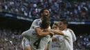 Sergio Ramos dipeluk oleh rekan-rekan setimnya usai mencetak gol pertama Madrid ke gawang Malaga. (AP Photo/Andres Kudacki)