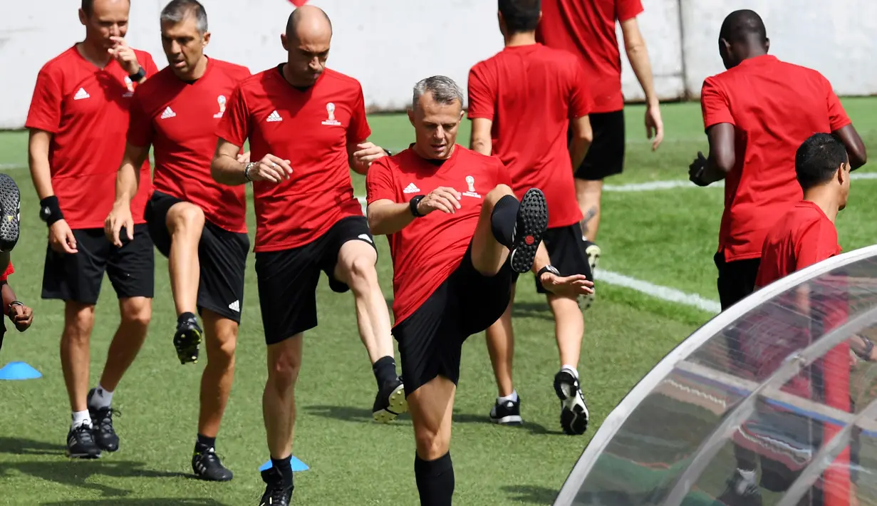 Para wasit melakukan pemanasan saat menjalani sesi latihan di Moskow, Rusia, Selasa (11/6). Persiapan dilakukan para wasit untuk menjaga kebugaran saat pertandingan turnamen Piala Dunia 2018 Rusia. (AFP Photo/Kirill Kudryavtsev)