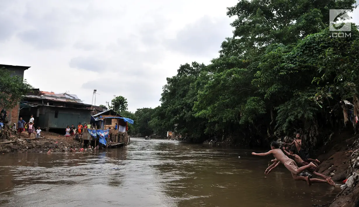 Anak-anak berenang di Kali Ciliwung, Bukit Duri, Jakarta, Kamis (12/4). Relokasi bangunan liar di sekitar kali nantinya bakal dilakukan untuk mengembalikan fungsinya. (Merdeka.com/Iqbal Nugroho)