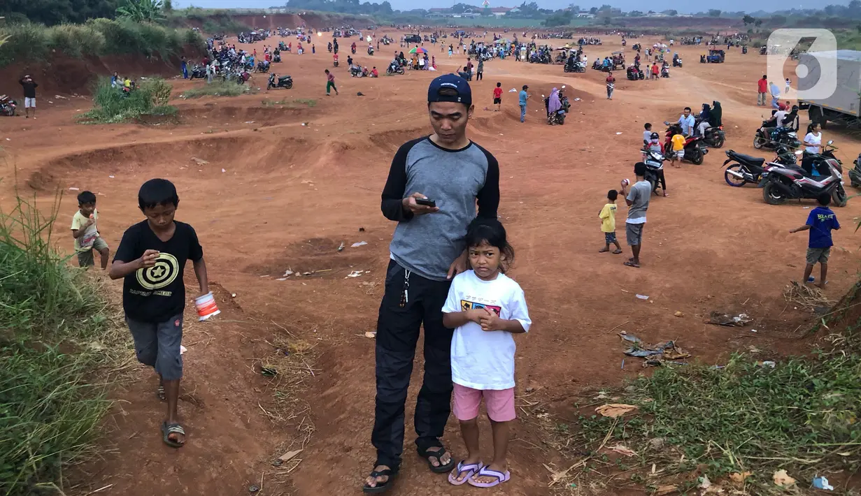 Warga menghabiskan waktu di tanah lapang kawasan Cipayung, Depok, Kamis (11/6/2020). Kurang tegasnya sanksi serta minimnya kesadaran masyarakat akan protokol kesehatan terkait covid-19 menyebabkan kawasan itu menjadi tempat berkerumun warga setiap sore hari. (Liputan6.com/Immanuel Antonius)