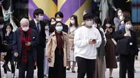 Sejumlah orang yang mengenakan masker pelindung untuk membantu mengekang penyebaran virus corona COVID-19 berjalan di Ginza, Tokyo, Jepang, Jumat (16/10/2020). Ibu Kota Jepang itu mengonfirmasi lebih dari 180 kasus virus corona COVID-19 baru pada hari Jumat. (AP Photo/Eugene Hoshiko)