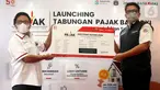 Direktur Ritel dan Syariah Bank DKI Babay Parid Wazdi (kiri) memberikan Sertifikat Kepemilikan Tabungan Pajak kepada Wakil Kepala Bapeda DKI, Elvarinsa pada peluncuran Tabungan Pajak Bank DKI di Jakarta (30/3/2022). Melalui Tabungan Pajak, wajib pajak dapat menabung terjadwal. (Liputan6.com/HO/BDKI)