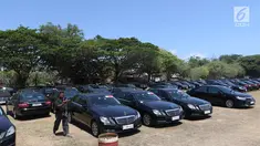 Seorang supir berjalan di antara mobil Toyota Camry dan Mercy E200 di Lapangan Lagoon Bali, Nusa Dua, Selasa (9/10). Sebanyak 865 unit kendaraan disiapkan untuk mengangkut delegasi Pertemuan Tahunan IMF-World Bank di Bali. (Liputan6.com/Angga Yuniar)