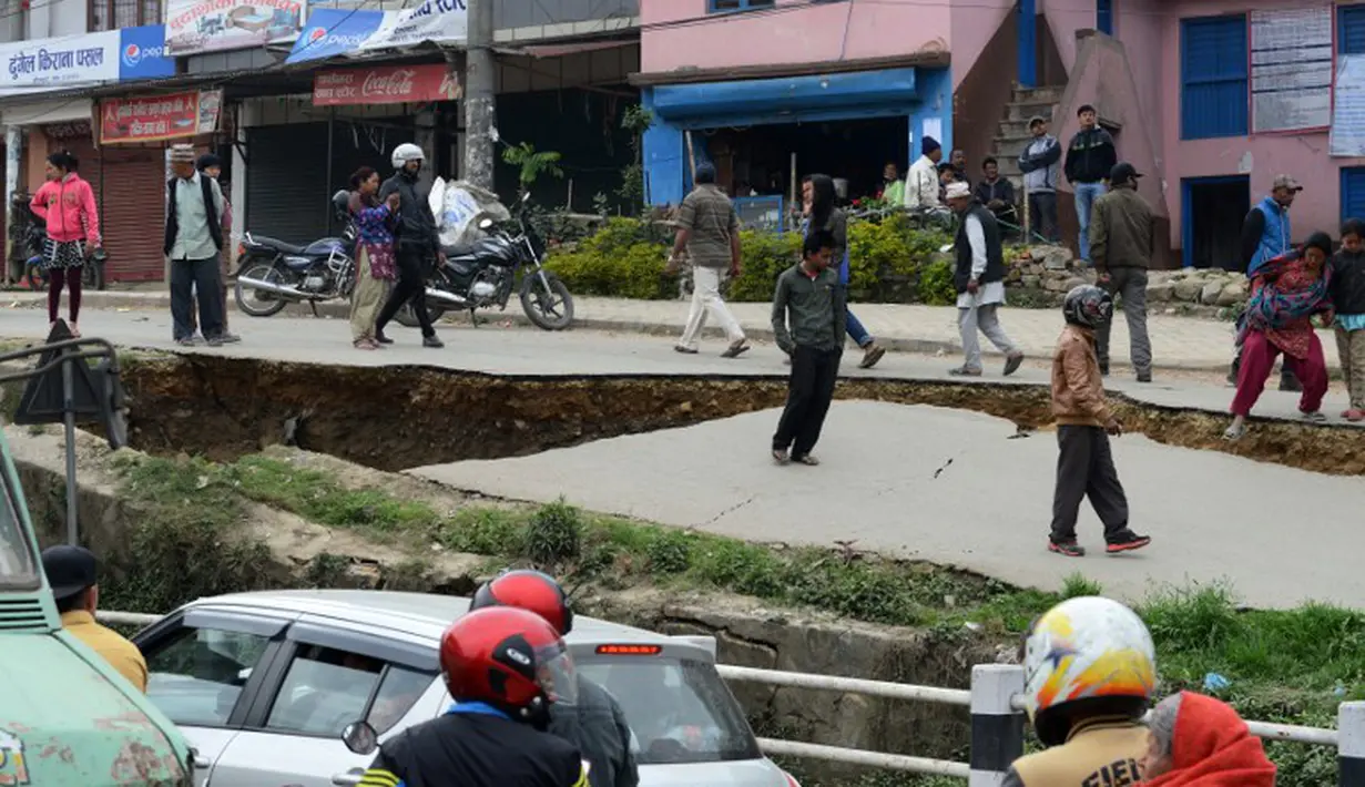 Penampakan jalan di Kathmandu yang rusak parah akibat gempa bumi yang menghantam Nepal, Minggu (26/4/2015). Gempa berkekuatan 7,8 Skala Richter dikabarkan telah menelan korban sekitar 2000 jiwa. (AFP Photo/Prakash Mathema)