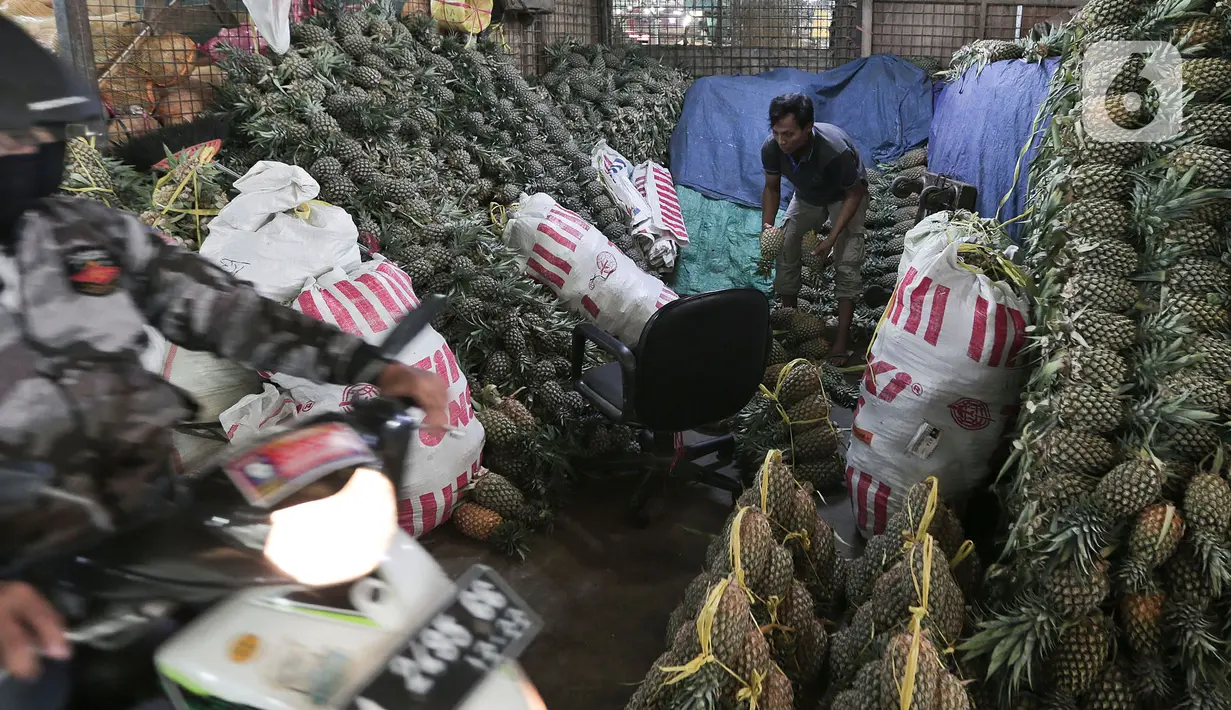 Aktivitas pedagang buah di salah satu kios Pasar Induk Kramat Jati, Jakarta Timur, Minggu (12/4/2020). Kegiatan di pasar tersebut berjalan normal selama pandemi COVID-19, namun penjual dan pekerja masih terlihat belum mengenakan masker. (Liputan6.com/Johan Tallo)