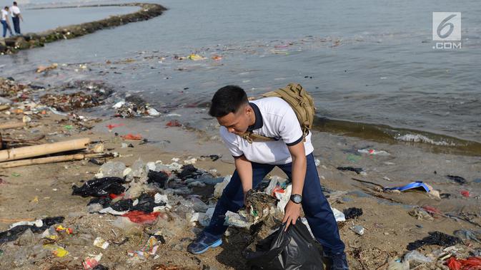 Prajurit TNI Angkatan Laut (AL)  membersihkan sampah di kawasan Pantai Ancol, Jakarta, Jumat (1/3). Kegiatan bersih-bersih itu menjadi giat yang bersifat keluarga dan melibatkan sejumlah elemen masyarakat. (Merdeka.com/ Imam Buhori)