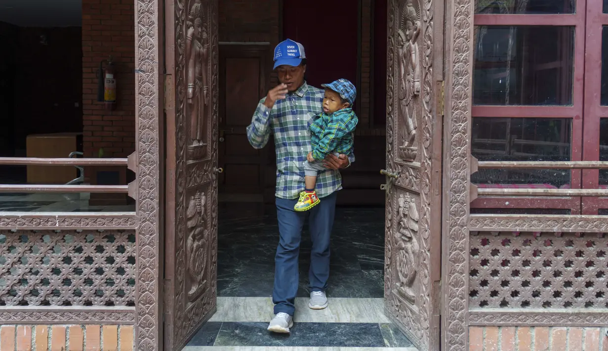 <p>Dor Bahadur Khapangi digendong oleh seorang anggota keluarga saat tiba untuk acara penyerahan sertifikat Rekor Dunia Guinness di Kathmandu, Nepal, Selasa (24/5/2022). Khapangi yang memiliki tinggi 2 kaki 4,9 inci (73,43 meter), dinobatkan sebagai remaja terpendek di dunia oleh Guinness World Records. (AP Photo/Niranjan Shrestha)</p>