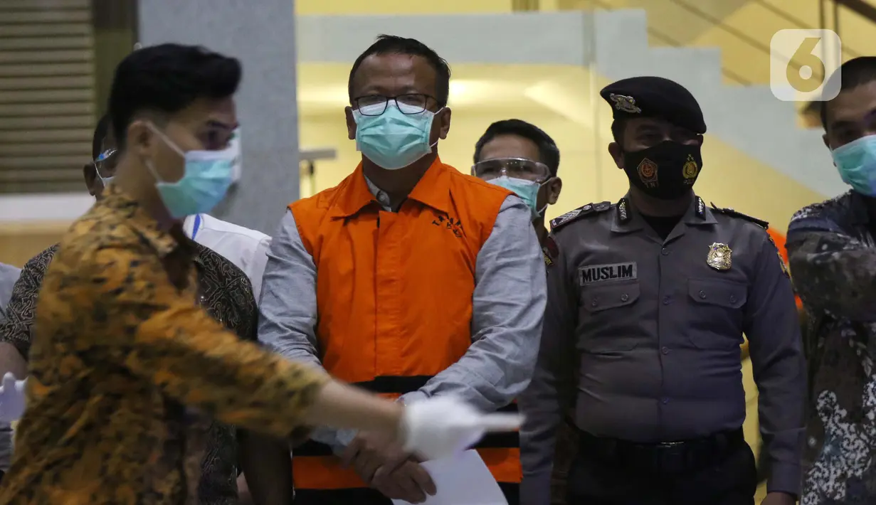 Menteri Kelautan dan Perikanan, Edhy Prabowo (tengah) digiring petugas sesaat sebelum rilis penetapan tersangka kasus dugaan suap penetapan calon eksportir benih lobster di Gedung KPK Jakarta, Rabu (25/11/2020). Edhy ditahan KPK bersama empat orang lainnya. (Liputan6.com/Helmi Fithriansyah)