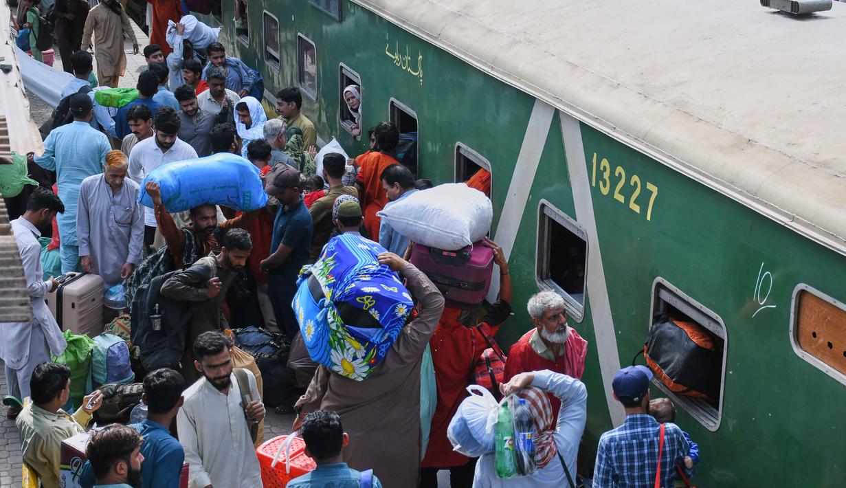 Terbatasnya moda transportasi menjadi salah satu penyebab melonjaknya pemudik kereta api. Tampak dalam foto, orang-orang menaiki kereta penumpang untuk pulang ke kampung halaman untuk Hari Raya Idul Fitri yang akan datang, sekaligus menandai berakhirnya bulan suci Ramadan, di sebuah stasiun kereta api di Karachi, Pakistan, Selasa 17 Maret 2026. (AP Photo/Ali Raza)