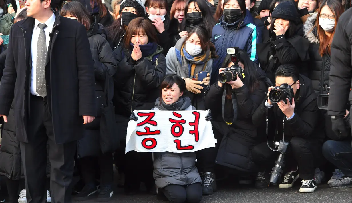 Namun memorial sementara itu menjadi berantakan hingga para penggemarnya pun merapikannya sendiri. (JUNG Yeon-Je/AFP)