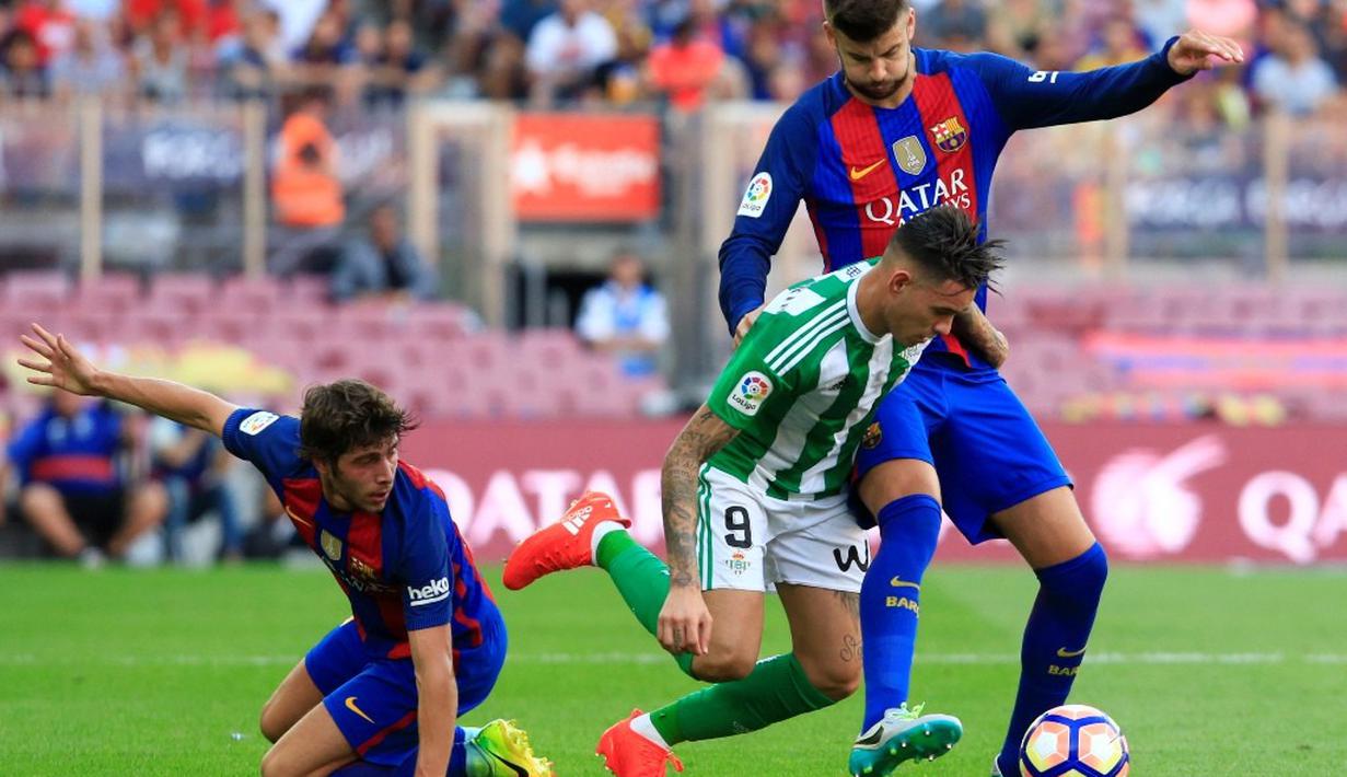 Duel antara pemain Barcelona dan Real Betis dalam laga La Liga di Stadion Camp Nou, Minggu (21/8/2016) dini hari WIB. (AFP/Pau Barrena)