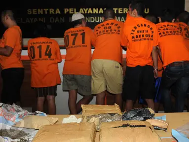 Barang bukti Narkoba beserta tersangka saat digelar rilis di Polres Jakarta Timur, Sabtu (6/2). Sebanyak 3,1 kg Ganja dan 1/4 kg sabu dan 419 butir pil ekstasy diamankan petugas Polres Jakarta Timur. (Liputan6.com/Helmi Afandi)