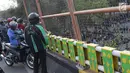 Warga menyaksikan aksi unjuk rasa yang dilakukan mahasiswa dari berbagai perguruan tinggi di sekitar Jembatan Layang Gerbang Pemuda, Jakarta, Selasa (1/10/2019). Mahasiswa dari berbagai perguruan tinggi kembali berunjuk rasa menolak beberapa RUU. (Liputan6.com/Helmi Fithriansyah)