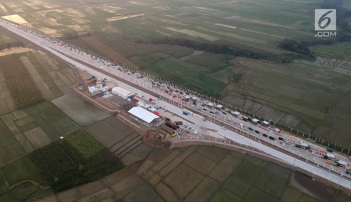 Foto udara antrean kendaraan pemudik di jalur tol fungsional GT Kertasari, Tegal, Minggu (10/6). Di pintu tol tersebut, ada 13 gardu yang dibuka untuk melayani pembayaran terakhir tarif tol dari Jakarta hingga Brebes Timur. (Liputan6.com/Arya Manggala)