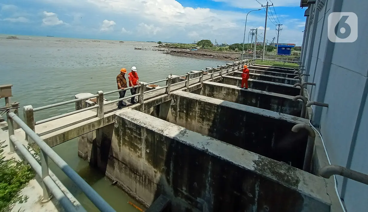 Petugas Dinas Pekerjaan Umum (PU) Kota Semarang memeriksa aliran air di Rumah Pompa Kali Semarang, Jawa Tengah, Kamis (2/1/2020). Dinas PU Kota Semarang melakukan pengerukan sedimentasi dan sampah, persiapan rumah pompa, dan normalisasi saluran air untuk mengantisipasi banjir. (Liputan6.com/Gholib)