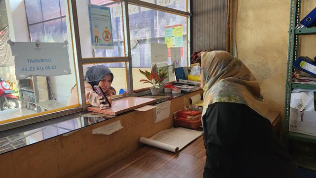 Seorang warga sedang meminta pelayanan administrasi di kantor Kelurahan Pasir Putih, Depok.
