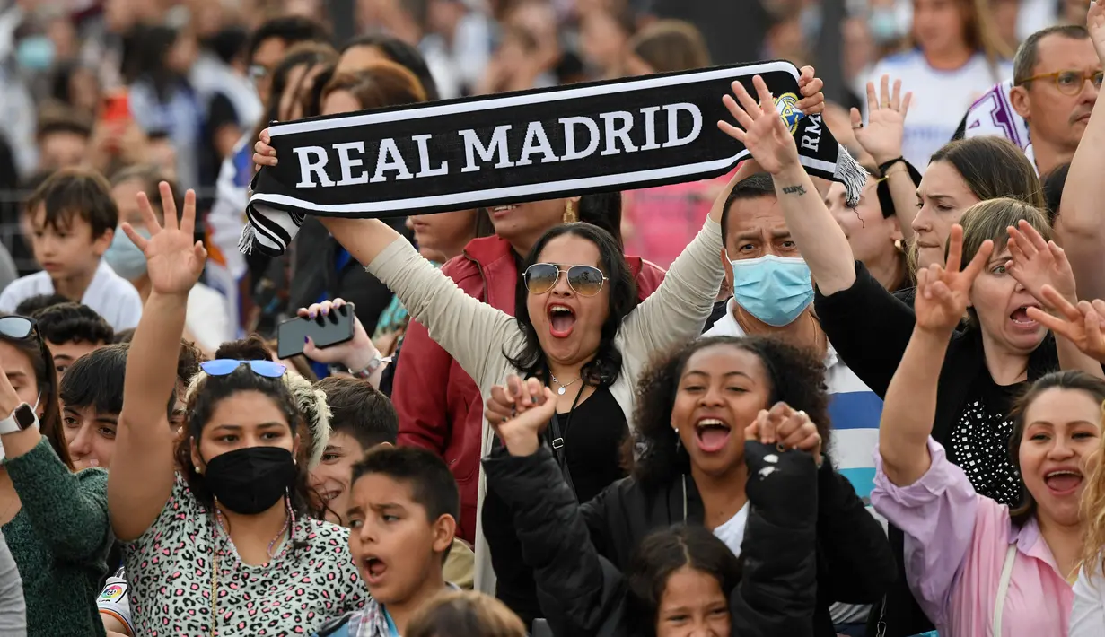 <p>Suporter Real Madrid berkumpul merayakan trofi La Liga Spanyol di alun-alun Plaza Cibeles di Madrid pada 30 April 2022. Real Madrid mengamankan gelar La Liga ke-35  setelah kemenangan kandang 4-0 atas Espanyol. (AFP/Oscar Del Pozo)</p>