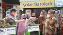 PT. Asuransi Kredit Indonesia (Askrindo), Anggota Holding Perusahaan Asuransi dan Penjaminan, Indonesia Finansial Grup (IFG) memberikan bantuan CSR kepada alumni program kartu prakerja berupa mesin pemarut singkong, showcase, kulkas, dan meja kursi di Kota Bogor. (Liputan6.com/HO/Askrindo)