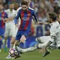 Lionel Messi mendapat adangan dari bek Real Madrid, Sergio Ramos dpada duel El Clasico di Santiago Bernabeu stadium, Madrid, Spanyol, Minggu, (23/4/2017). Barcelona menang 3-2.  (AP/Daniel Ochoa de Olza)