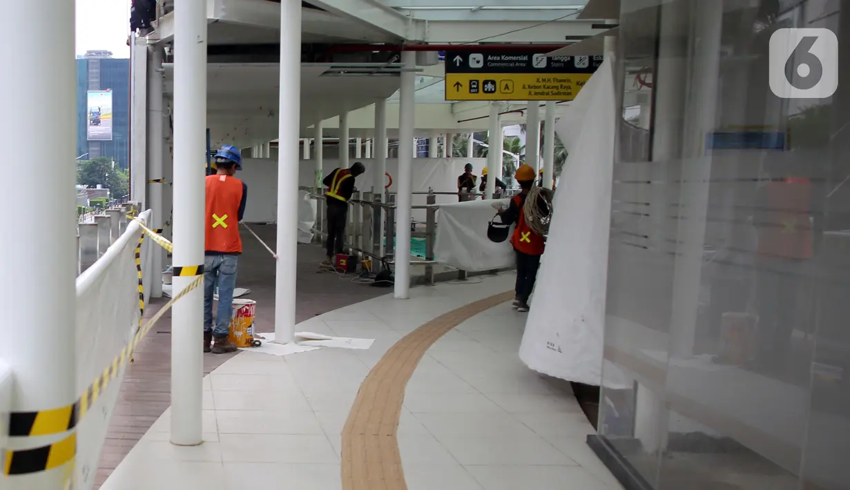 Pekerja menyelesaikan pengerjaan anjungan Halte Transjakarta Bundaran HI saat uji coba anjungan itu di kawasan Bundaran Hotel Indonesia, Jakarta, Senin (10/10/2022). Lokasi tersebut jadi spot foto baru dengan latar belakang Patung Selamat Datang dan air mancur Bundaran HI. (Liputan6.com/Johan Tallo)