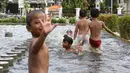 Anak-anak bermain di kolam air mancur penghias kawasan Pasar Baru, Jakarta, Selasa (29/1). Keterbatasan lahan bermain menyebabkan sebagian anak di Ibukota bermain tidak pada tempatnya, meskipun berbahaya bagi keselematan. (Liputan6.com/Immanuel Antonius)