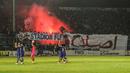 Suporter Arema Indonesia menyalakan flare usai laga semifinal leg pertama Piala Presiden di Stadion Kanjuruhan, Malang, Sabtu (3/10/2015). Arema imbang dengan Sriwijaya FC 1-1. (Bola.com/Kevin Setiawan)