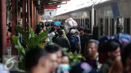 Para pemudik pengguna jasa transportasi kereta api memadati Stasiun Senen, Jakarta, Kamis (16/7/2015). Memasuki H-1 Lebaran, Stasiun Pasar Senen memberangkatkan sebanyak 8.443 pemudik. (Liputan6.com/Faizal Fanani)