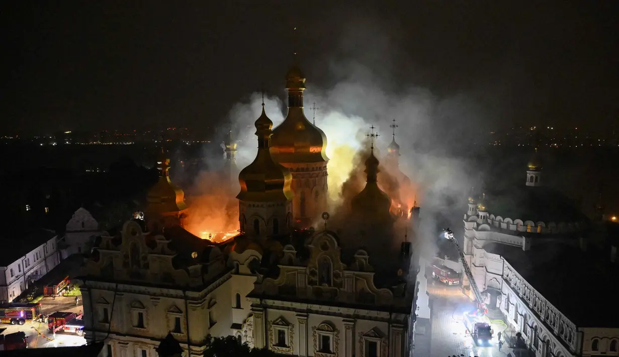 Asap dan api membubung dari Katedral Dormition, kompleks Ortodoks Kyiv Pechersk Lavra setelah serangan rudal Rusia di ibu kota Ukraina, Kyiv, Senin 15 Juni 2026, di tengah invasi Rusia. (Genya Savilov/AFP)
