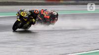 Pembalap MotoGP dari Mooney VR46 Racing Team, Luca Marini (kiri) beradu kecepatan dengan Brad Binder (Red Bull KTM Factory Racing) di lintasan Pertamina Mandalika International Street Sirkuit, Nusa Tenggara Barat, Minggu (20/3/2022). (Liputan6.com/Helmi Fithriansyah)