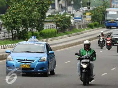 Pengendara ojek on line melintas di Jalan Gatot Subroto, Jakarta, Jumat (18/12/2015). Setelah sempat dilarang pengoperasiannya oleh Kementerian Perhubungan, kini ojek online diperbolehkan beroperasi kembali. (Liputan6.com/Helmi Fithriansyah)