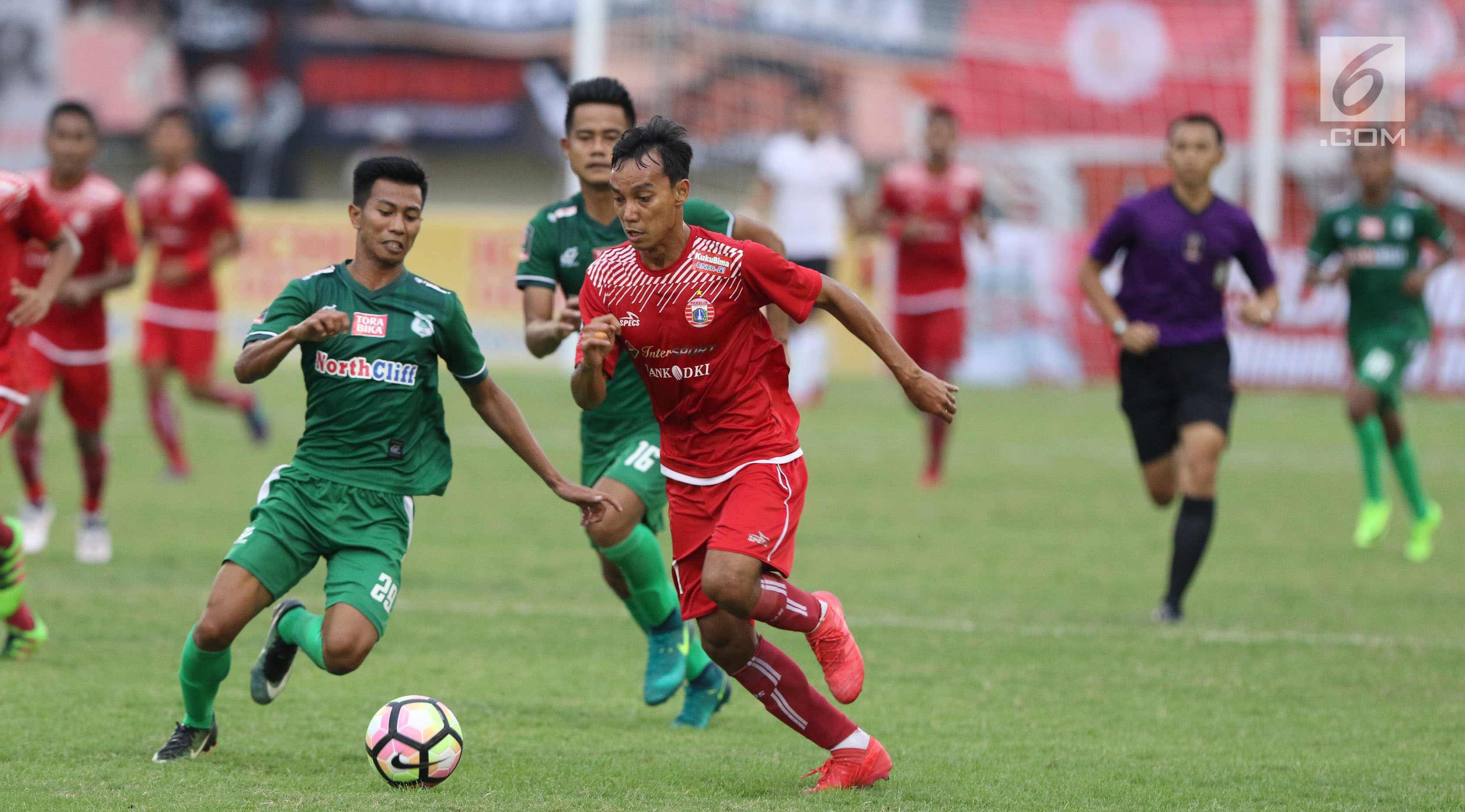 Penyerang Persija, Novri Setiawan (tengah) mencoba melewati hadangan pemain PSMS, Suhandi pada laga kedua Semifinal Piala Presiden 2018 di Stadion Manahan, Solo, Jawa Tengah, Senin (12/2). Persija unggul 1-0. (Liputan6.com/Helmi Fithriansyah)