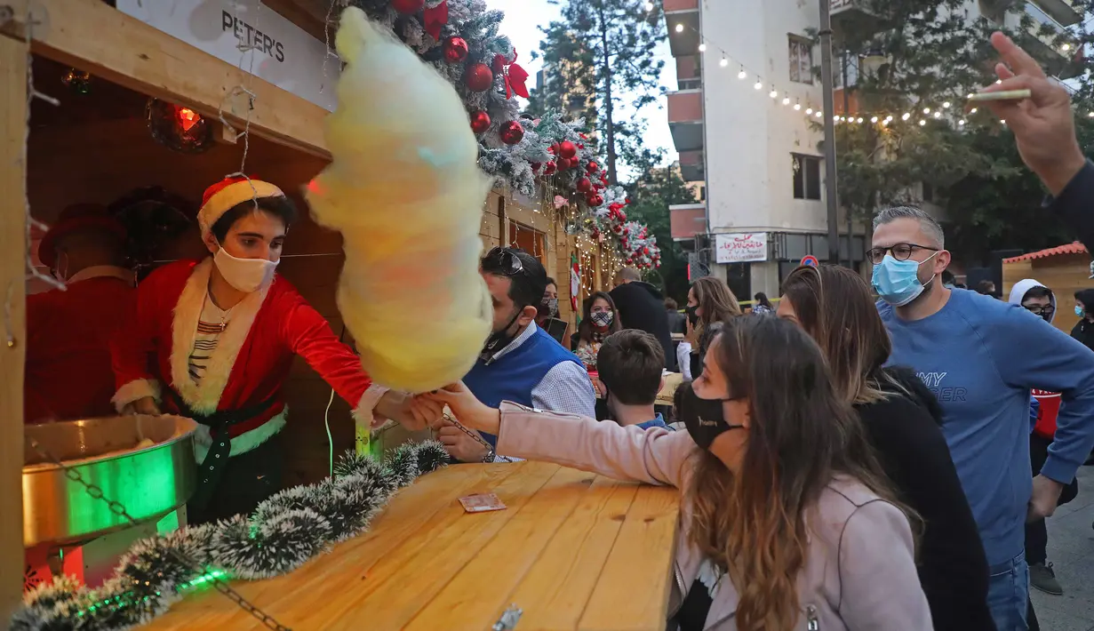 Orang-orang berbelanja di kampung Natal di daerah Ashrafieh, Beirut, Lebanon, 6 Desember 2020. Sebuah kampung Natal dibuka pada Minggu (6/12) bagi para pedagang yang tokonya hancur akibat ledakan pelabuhan pada 4 Agustus lalu. (Xinhua/Bilal Jawich)