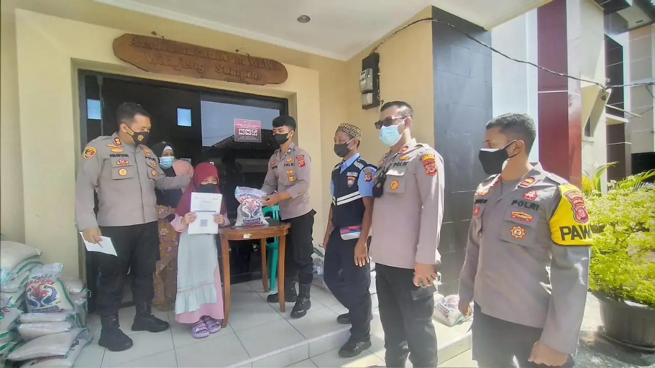 Seorang warga yang telah divaksin mendapatkan satu paket beras 5 kg dari polres Tasikmalaya, Jawa Barat.